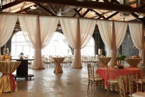 The venue, in this photo, is set up for a wedding reception.